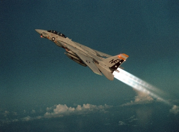 F-14 Tomcat Fighter climbs with its afterburners ignited during a take-off of the aircraft carrier USS RANGER. May 1 1989. (BSLOC_2011_12_216)